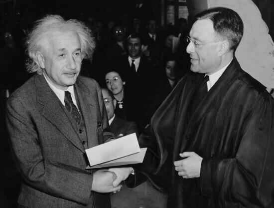 Albert Einstein receiving from Judge Phillip Forman his certificate of American citizenship.