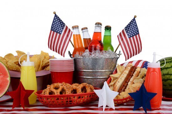 A picnic table set up with a Fourth of July theme. Horizontal fo